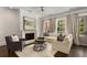 Bright living room featuring a fireplace, multiple windows, hardwood flooring and modern furnishings at 304 Stonemont Dr, Atlanta, GA 30305