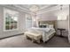 Serene main bedroom with a crystal chandelier, tray ceiling, and bench offering a tranquil retreat at 304 Stonemont Dr, Atlanta, GA 30305