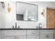 Stylish bathroom with double vanity, modern fixtures, sleek mirrors, and a sliding barn door at 3200 Lowndes St, East Point, GA 30344