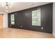 Modern bedroom with hardwood floors, a unique feature wall and natural light from two windows at 3200 Lowndes St, East Point, GA 30344