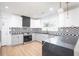 Modern kitchen features white cabinets, stainless steel appliances, a gas range, and striking black countertops at 3200 Lowndes St, East Point, GA 30344