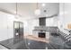 Modern kitchen features white cabinets, stainless steel appliances, a gas range, and striking black countertops at 3200 Lowndes St, East Point, GA 30344