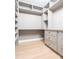 Home office features custom shelving and storage with light hardwood floors at 3200 Lowndes St, East Point, GA 30344