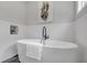 Modern bathtub and decorative wall in remodeled bathroom at 656 S Elizabeth Nw Pl, Atlanta, GA 30318