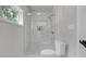 Modern bathroom with a glass enclosed shower, white tile and contrasting fixtures at 656 S Elizabeth Nw Pl, Atlanta, GA 30318
