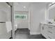 Bright bathroom features black tile floors, tub, shower, and modern sink at 656 S Elizabeth Nw Pl, Atlanta, GA 30318