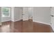 Bedroom with hardwood floors, neutral paint, white trim, and a view of the stairs at 656 S Elizabeth Nw Pl, Atlanta, GA 30318