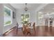 Cozy dining area featuring a modern light fixture, glass table, and seamless access to the outdoor patio and kitchen at 656 S Elizabeth Nw Pl, Atlanta, GA 30318