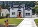 Beautifully renovated two-story home with a fresh, well-kept lawn and a paved driveway leading to the property at 656 S Elizabeth Nw Pl, Atlanta, GA 30318
