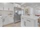 Contemporary kitchen featuring white cabinets, stainless steel appliances, and an island with seating at 656 S Elizabeth Nw Pl, Atlanta, GA 30318