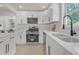 Bright, modern kitchen featuring white cabinetry, stainless steel appliances, and sleek countertops for a clean aesthetic at 656 S Elizabeth Nw Pl, Atlanta, GA 30318