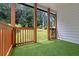Cozy back porch featuring artificial grass and wood columns at 656 S Elizabeth Nw Pl, Atlanta, GA 30318