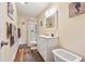 Well-lit bathroom boasts a shower, white cabinets, and flooring and decorative accents at 672 Victorian Cir, Dallas, GA 30157