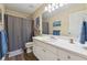 Bathroom featuring a shower, toilet, and vanity with mirror, complemented by blue towels at 672 Victorian Cir, Dallas, GA 30157