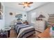 Comfortable bedroom with ceiling fan, window and a white dresser for ample storage space at 672 Victorian Cir, Dallas, GA 30157