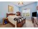 Bedroom with natural light, desk, wood furniture, and neutral-toned carpet at 672 Victorian Cir, Dallas, GA 30157