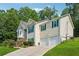 Beautiful home with a two car garage, pretty green shutters, and lush green lawn in a suburban neighborhood at 672 Victorian Cir, Dallas, GA 30157