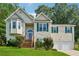 Charming home featuring a well-manicured lawn, a 2-car garage, and a inviting front porch with wood stairs at 672 Victorian Cir, Dallas, GA 30157