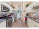 Well-equipped kitchen features granite countertops, a gas range, stainless steel appliances, and white cabinetry at 672 Victorian Cir, Dallas, GA 30157