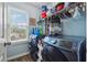 Laundry room with large washer and dryer, window and ample storage space above at 672 Victorian Cir, Dallas, GA 30157