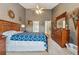 Spacious main bedroom features a ceiling fan, ensuite bath, and a large dresser with mirror at 672 Victorian Cir, Dallas, GA 30157
