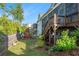 Backyard featuring a screened-in porch, wooden playset, and lush greenery at 2208 Sage Mountain Sw Ct, Marietta, GA 30064