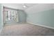 Spacious bedroom with mint walls, a large window, plush carpeting, and a vaulted ceiling at 2208 Sage Mountain Sw Ct, Marietta, GA 30064