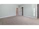 Airy bedroom with mint walls, plush carpeting, and bright white trim, doors, and closet at 2208 Sage Mountain Sw Ct, Marietta, GA 30064