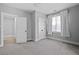 Neutral bedroom featuring multiple doors, a window, and plush carpeting at 2208 Sage Mountain Sw Ct, Marietta, GA 30064