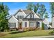 Beautiful home boasts a well-manicured lawn, stylish gray siding, and black trim at 2208 Sage Mountain Sw Ct, Marietta, GA 30064