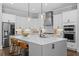 Gourmet kitchen with white cabinets, stainless appliances, and a quartz countertop island at 2208 Sage Mountain Sw Ct, Marietta, GA 30064