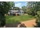 Aerial view of a sprawling green backyard, mature trees, and exterior of the home at 230 Thistlewood Ln, Roswell, GA 30075