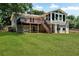 A sprawling lawn with a deck, stairs, and a fenced yard at 230 Thistlewood Ln, Roswell, GA 30075