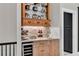 An elegant bar area with custom cabinetry, marble counters and wine fridge at 230 Thistlewood Ln, Roswell, GA 30075