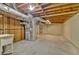 Unfinished basement with exposed beams and ductwork, offering potential for customization at 230 Thistlewood Ln, Roswell, GA 30075