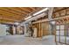 Unfinished basement with exposed beams and ductwork, offering potential for customization at 230 Thistlewood Ln, Roswell, GA 30075