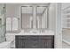 Elegant bathroom boasts double vanity with modern fixtures, marble countertop and stylish mirrors at 230 Thistlewood Ln, Roswell, GA 30075