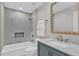 Bright bathroom with marble countertops, modern fixtures, and tiled shower/tub combination at 230 Thistlewood Ln, Roswell, GA 30075