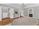 Bedroom with neutral walls and wood floors, featuring a decorative rug, drawers and closet at 230 Thistlewood Ln, Roswell, GA 30075