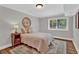 Comfortable bedroom with a cozy bed, bedside table, and a window for natural light at 230 Thistlewood Ln, Roswell, GA 30075