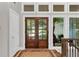 Stunning entryway with glass paneled double doors, and hardwood flooring at 230 Thistlewood Ln, Roswell, GA 30075