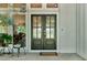 Inviting entrance featuring a stained wood double front door with glass inserts and a charming porch with seating at 230 Thistlewood Ln, Roswell, GA 30075