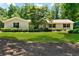 Charming single-story home with a lush front yard and well-manicured landscaping at 230 Thistlewood Ln, Roswell, GA 30075