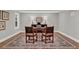 Spacious home office with a large desk, comfortable seating, and ample natural light at 230 Thistlewood Ln, Roswell, GA 30075