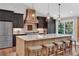 Stunning kitchen with a large island with seating, custom cabinetry, and pendant lighting at 230 Thistlewood Ln, Roswell, GA 30075