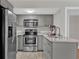 Modern kitchen featuring stainless steel appliances, granite countertops, and ample cabinet space at 230 Thistlewood Ln, Roswell, GA 30075