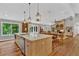 Spacious kitchen featuring large island, stainless appliances, and an open dining area with fireplace at 230 Thistlewood Ln, Roswell, GA 30075