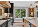 Well-equipped kitchen featuring a large range, stainless appliances, and a view of the trees at 230 Thistlewood Ln, Roswell, GA 30075