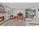 Open living room with stone fireplace, wood floors, and seamless flow to dining and kitchen at 230 Thistlewood Ln, Roswell, GA 30075
