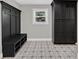 Mud room with coat rack, seat and storage, as well as cabinets and a tiled floor at 230 Thistlewood Ln, Roswell, GA 30075